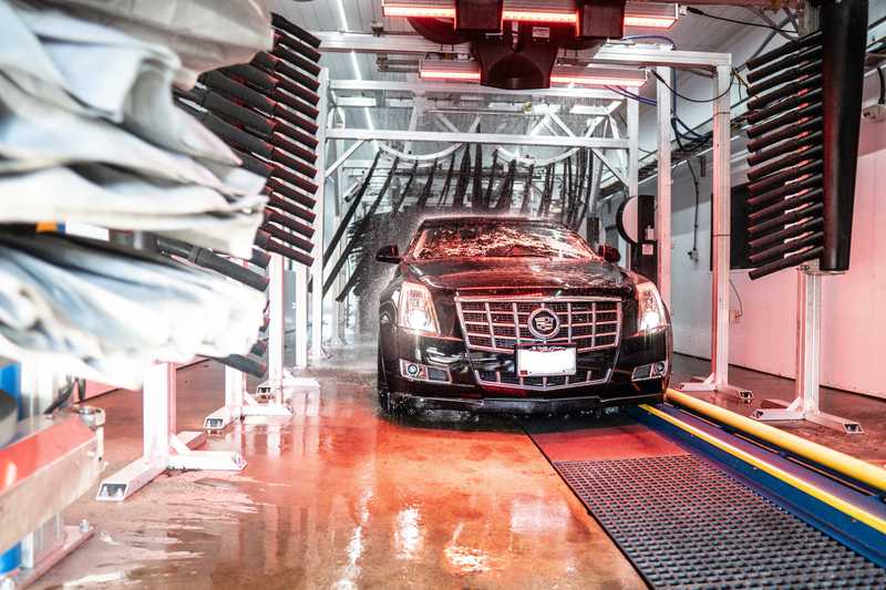 Black Cadillac getting a car wash in Gahanna Ohio